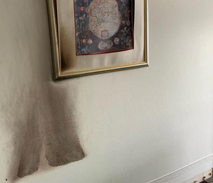 fire damage to wall and picture