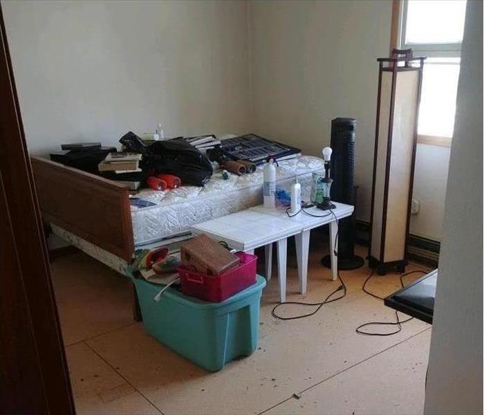 A room full of a customer's possessions and a bed