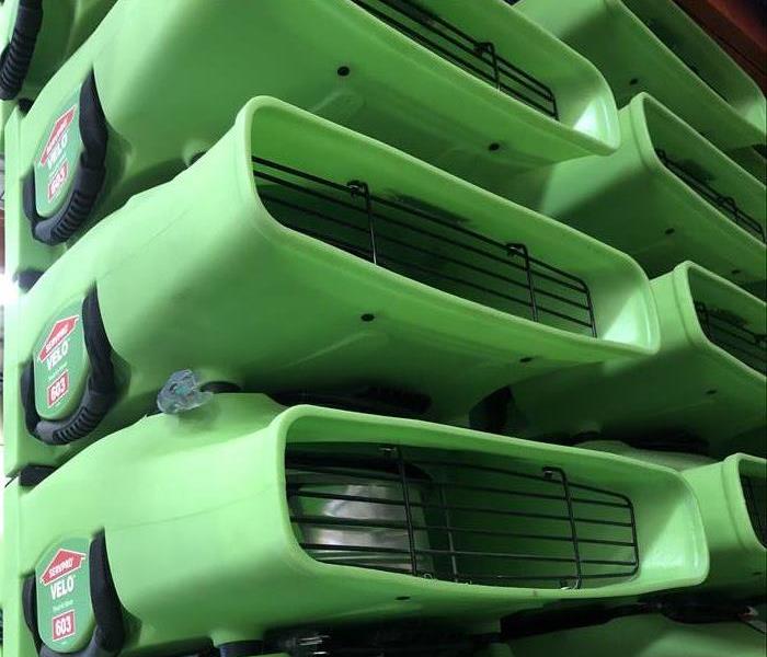 stack of green SERVPRO air movers for drying